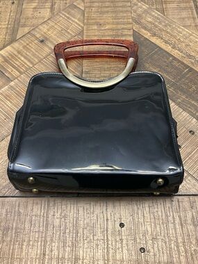 Vintage 1960s black patent leather handbag with faux tortoise shell handle